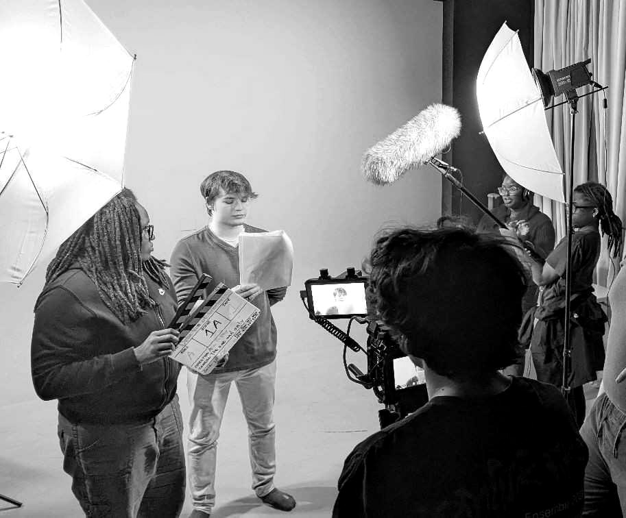 The full Reach Studio crew on a green screen set during a shoot, black and white